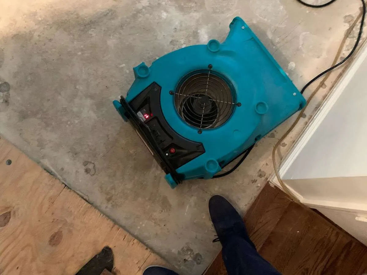 Air mover drying subfloor during Commercial Water Damage Restoration in Baldwinsville